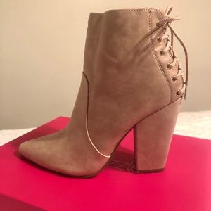 New. Tan pointed toe boots with laced up back.
